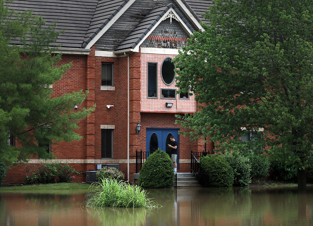 Floodwaters reach the steps of an office building on Forum Boulevard